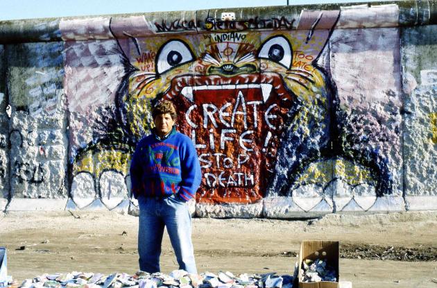 Man in front of the Berlin Wall